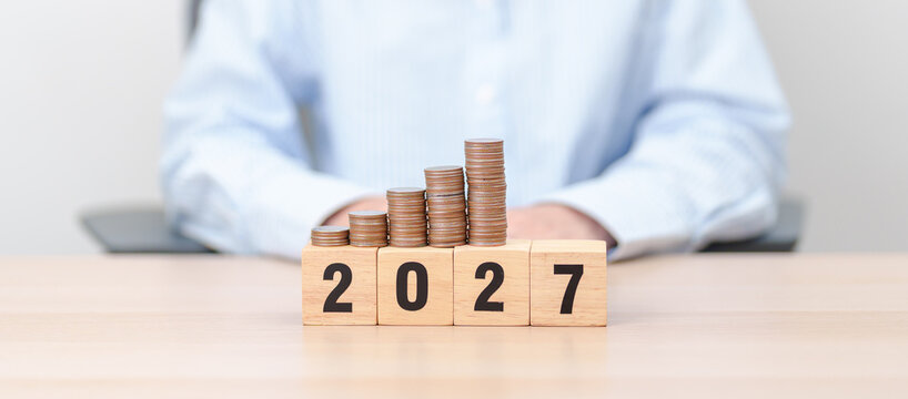 Happy New Year 2027 with Coins stack. Money, Budget, tax, investment, financial, savings and New Year Resolution concepts