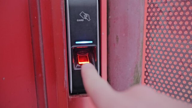 Finger activates biometric access as electronic security unlocks snowy entrance