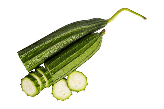 Whole ridge gourd with sliced rounds on transparent background