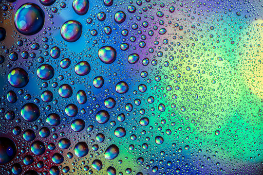 water drops macro photography with colorful rainbow reflections and colorful background