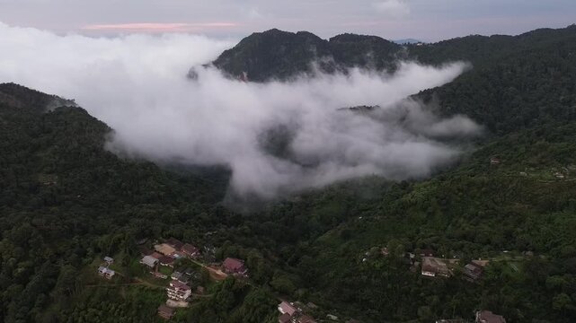 Misty Mountain Village in Tropical Valley with Forested Peaks, Cloudy Dawn Landscape, Peaceful Rural Homes, Remote Hillside Scenery, Quiet Natural Beauty and Mountain Mist