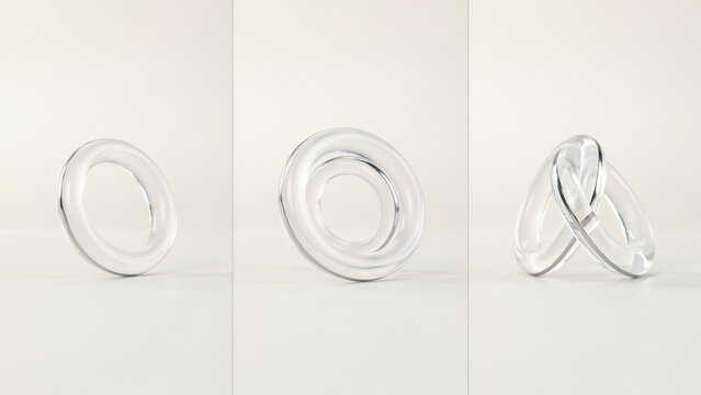 Clear glass ring shapes and interlocked circular forms on a soft neutral white background