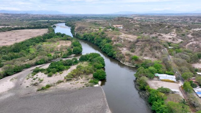 Magdalena River Flowing Through Natural Landscape in Huila, Colombia. Establishing Shot. Aerial View.
