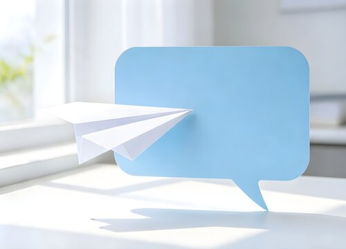 Paper plane flying toward blank blue speech bubble. Minimalist workspace, soft morning light, no text, no people. Concept of message, connection, sending mail.