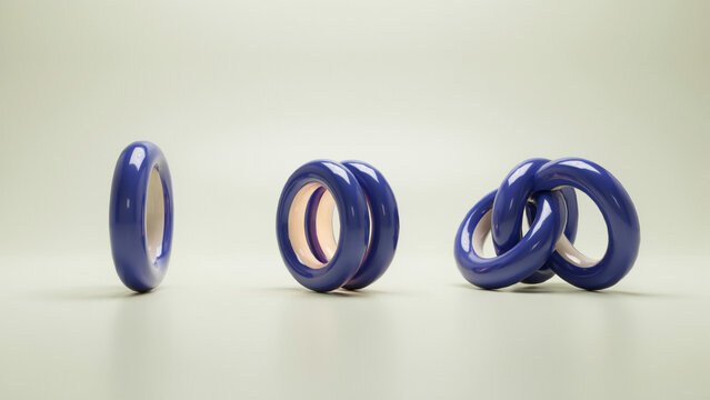 Three sets of interlocking blue ceramic rings on a soft light green background surface