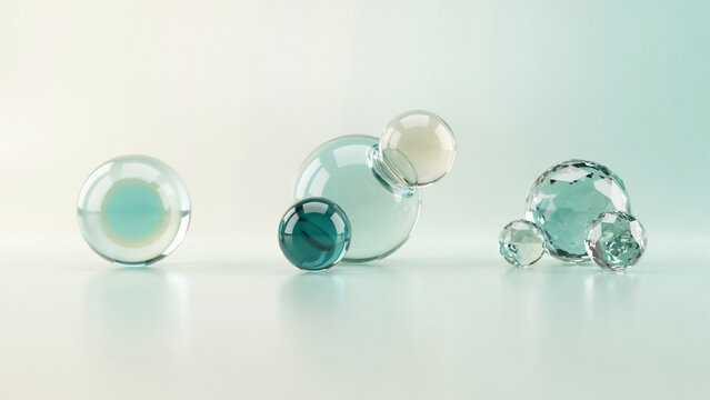 Translucent glass spheres and faceted crystal orbs on a soft light gradient background