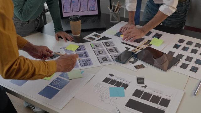 Ux ui designers collaborating on mobile application interface
