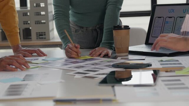 Ux ui designers collaborating on mobile application interface