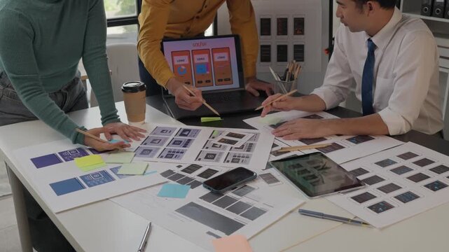 Ux ui designers collaborating on mobile app development