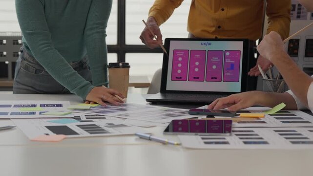 Ux ui designers collaborating on mobile application interface