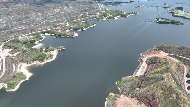Betania Dam and Hydroelectric Reservoir in Huila, Colombia. Establishing Shot. Aerial View.