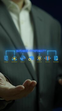 Businessman holding smartphone vertical shot below glowing business continuity text hub with risk and recovery icons. Corporate resilience planning, operational procedures, and emergency concept.