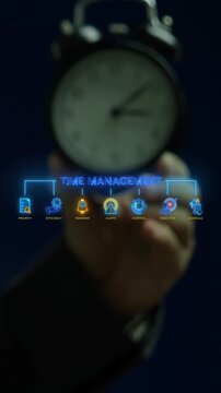 Businessman hand holding alarm clock vertical shot below glowing time management text hub with schedule icons. Workplace task priority control, deadline reminder alerts, and efficiency concept idea.