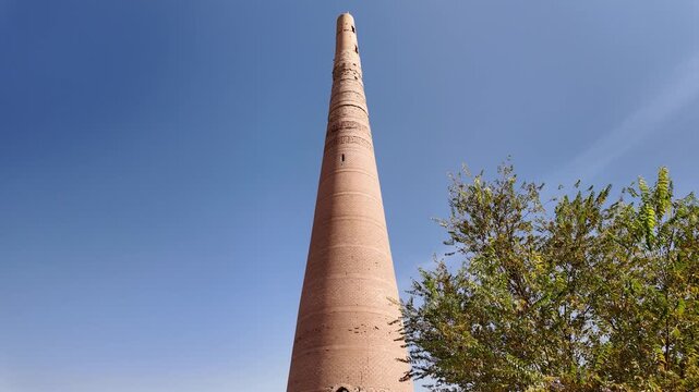 Tilt up view of tall brick Kutlug-Timur minaret, tallest in Central Asia, Turkmenistan