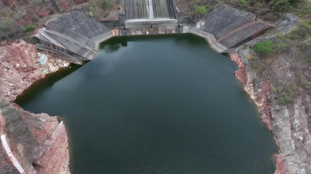 Betania Dam Spillway and Hydroelectric Infrastructure in Huila, Colombia. Establishing Shot. Aerial View.