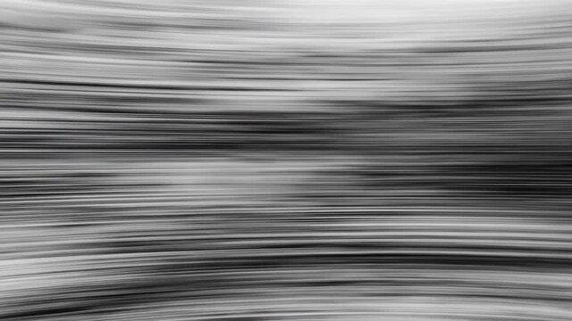 Abstract monochrome background with horizontal lines and motion blur effect.