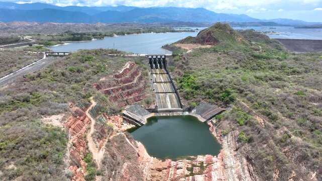 Betania Reservoir and Hydroelectric Dam Surrounded by Mountains in Colombia. Establishing Shot. Aerial View.