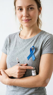 Woman with blue awareness ribbon insulin syringe and vial for diabetes treatment