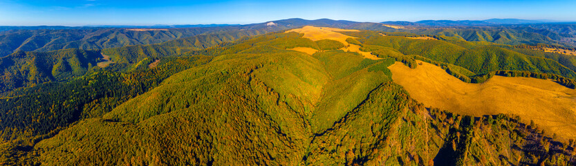 A panoramic aerial perspective of the Gurghiu Mountains, a volcanic mountain range located in the Eastern Carpathians of Transylvania, Romania © sebi_2569