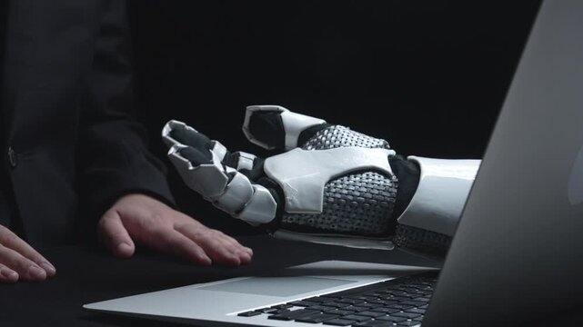 A robotic hand emerges from a laptop, symbolizing the fusion of technology and data analysis. This imagery emphasizes modern business strategies and cost management. Salient
