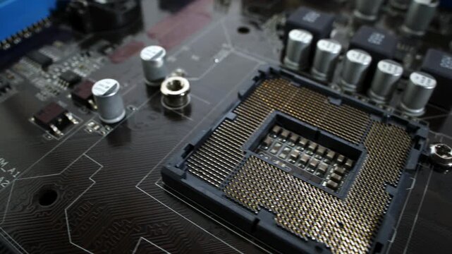 Close up motion footage of computer motherboard with CPU socket and RAM slots.