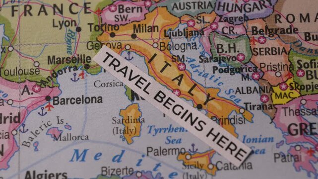 Travel Begins Here label placed on map of Italy and Europe