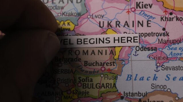Paper Strip Reading Travel Begins Here Placed On Map Of Europe