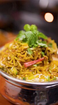 Close Up of Traditional Indian Chicken Biryani Rice in Metal Bowl