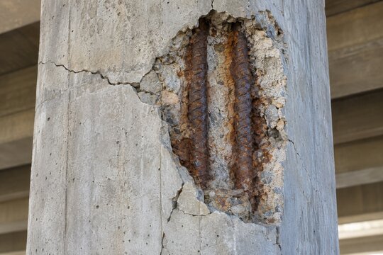 Concrete bridge column spalling with exposed corroded reinforcement