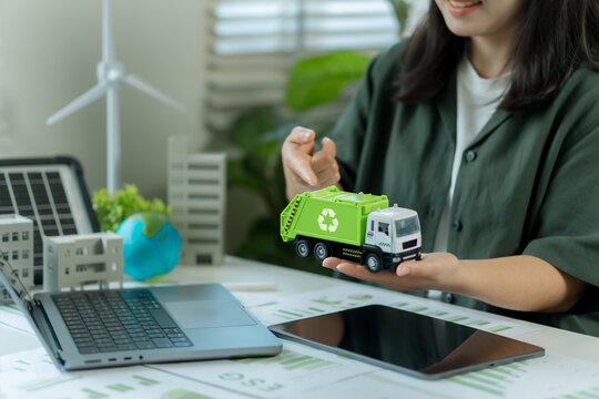 Businesswoman presents recycling concepts and renewable energy strategies to drive green business growth, zero waste, and sustainable environmental responsibility through clean energy.