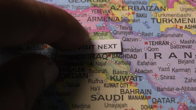 Paper tag Visit Next placed on Middle East map travel planning concept