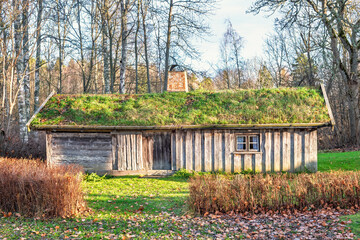 Old idyllic wooden cottage with a grass roof at the forest edge © Lars Johansson