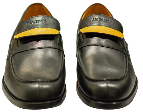 Black leather loafers with a double yellow tongue by Balenciaga for J.M. Weston. Milan, Italy, 5 October 2026