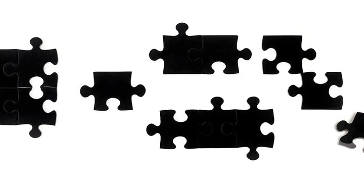 Scattered black puzzle pieces on a clean white background during a conceptual moment of disconnection