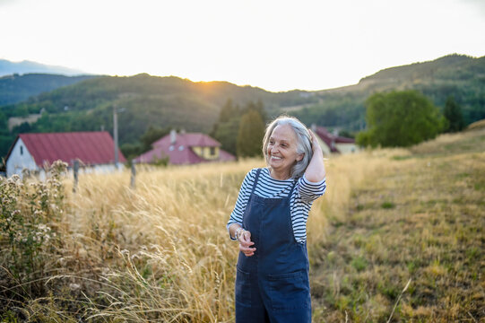 Senior woman enjoying gentle outdoor activity and connection with nature.