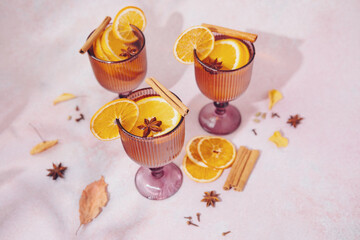 White mulled wine with orange slices and cinnamon sticks in glasses © reddish