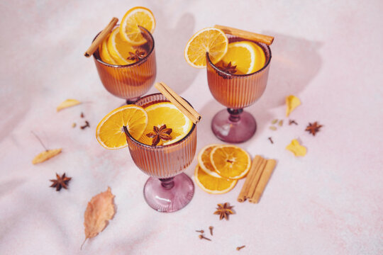 White mulled wine with orange slices and cinnamon sticks in glasses