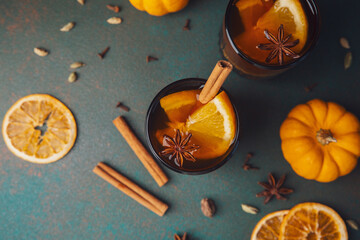 Fototapeta premium White mulled wine with orange and spices surrounded by pumpkins for autumn gatherings