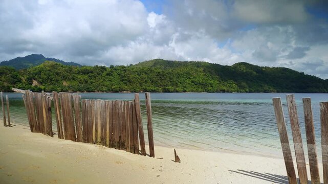 Tropical Beach With Rustic Wooden Fence and Calm Sea 4K