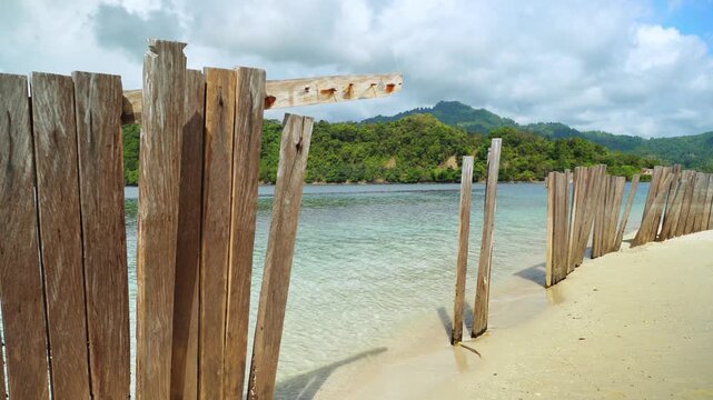 Wooden Fence Beside Tropical Beach and Clear Blue Sea 4K