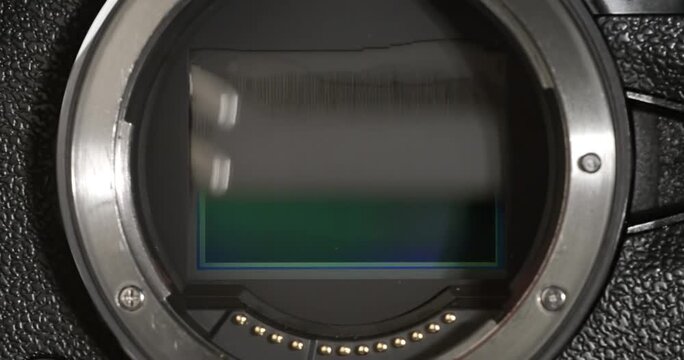 Camera shutter curtain mechanism movement in slow motion close up.