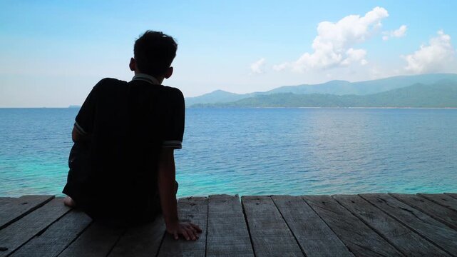 Silhouette of Young Man Looking at Tropical Ocean View 4K