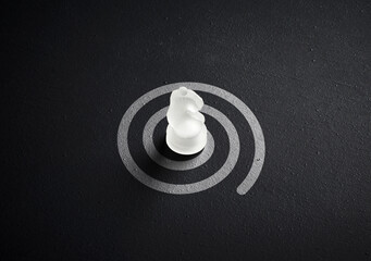 Chess knight targeting a spiral path strategy. Strategic challenge, finding a way out and problem solving concept. © Cagkan