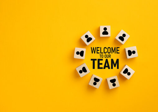 Welcome to our team concept with wooden blocks symbolizing new employee integration and recruitment