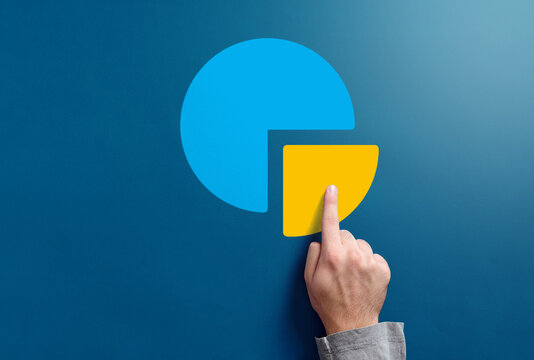 Hand pointing on pie chart segment representing data analysis