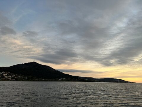 Mountain landscape at sunset over river Minho water, O Rosal, Galicia, Spain, March 2023
