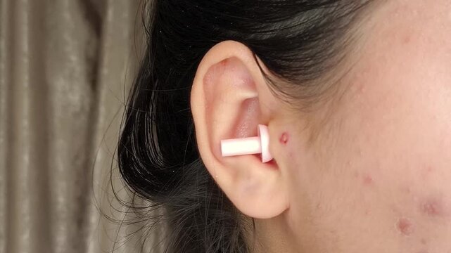 Close up of earplugs used to block unwanted noise, representing sleep disturbance, noisy neighbors and the need for sound protection.