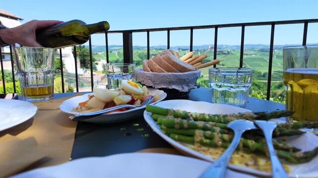 Pouring Water at an Outdoor Dining Table Overlooking Hills