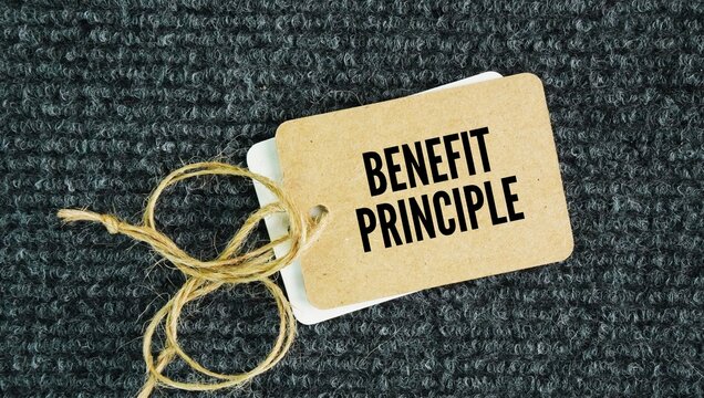 Paper tag with the words benefit principle is a taxation and economic theory stating that people should pay taxes and fees in proportion to the benefits they receive from public goods and services.