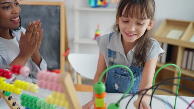 African tutor use educational toy help little child learn basic skills. 